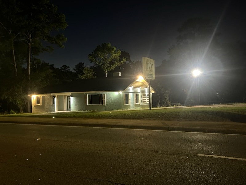 The Ivy House exterior lit at night from the street
